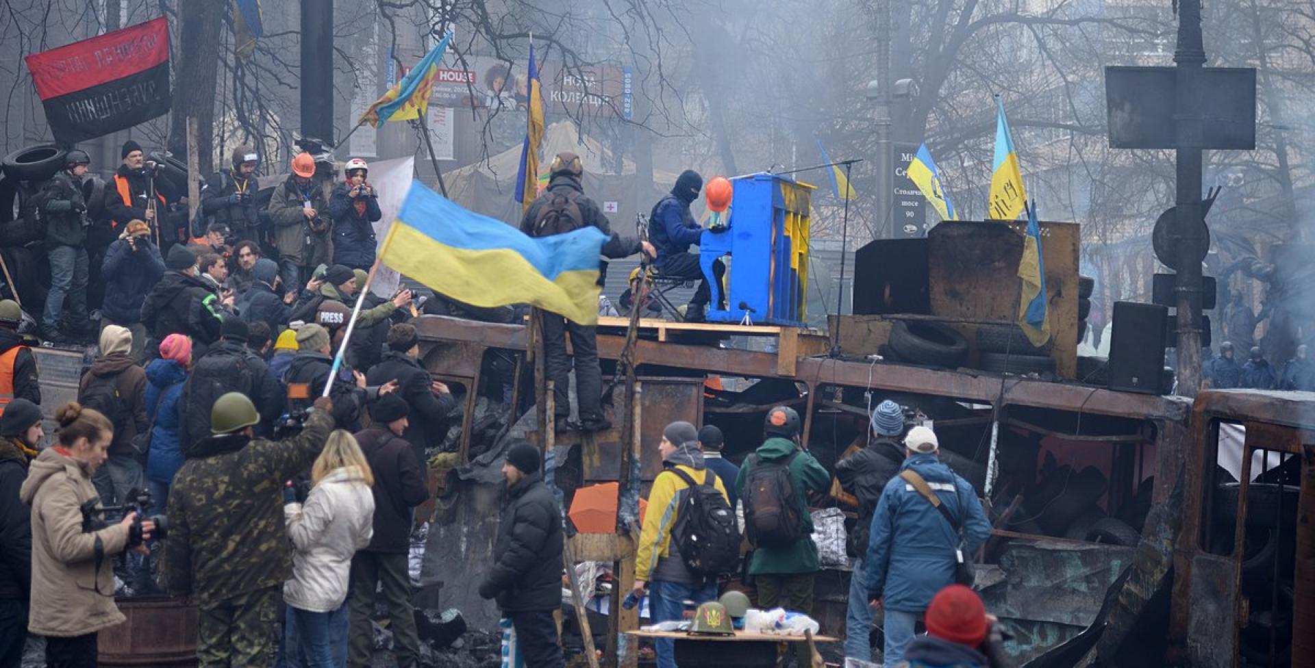 "Piano Extremist" is playing piano on the roof of a burned Berkut bus. The barricade across Hrushevskoho str. Kiev, 10 February 2014.